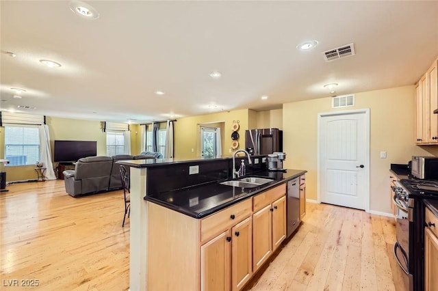 3168 Via Festiva, Henderson, NV 89044 - kitchen with stainless steel appliances, light wood-type flooring, light brown cabinetry, an island with sink, and recessed lighting