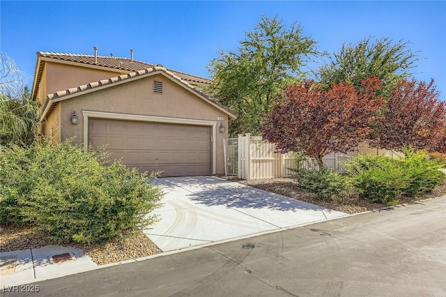 3168 Via Festiva, Henderson, NV 89044 - view of front facade featuring stucco siding, concrete driveway, a tile roof, and an attached garage