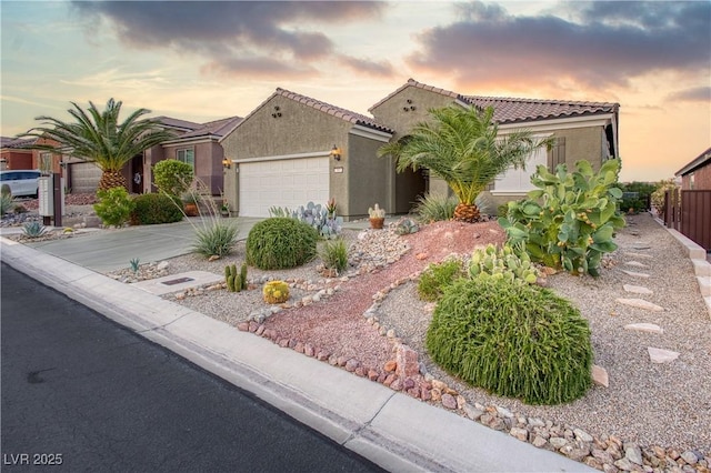 757 Bridle Path Ln, Mesquite, NV 89034 - mediterranean / spanish-style house featuring stucco siding, an attached garage, concrete driveway, and a tile roof