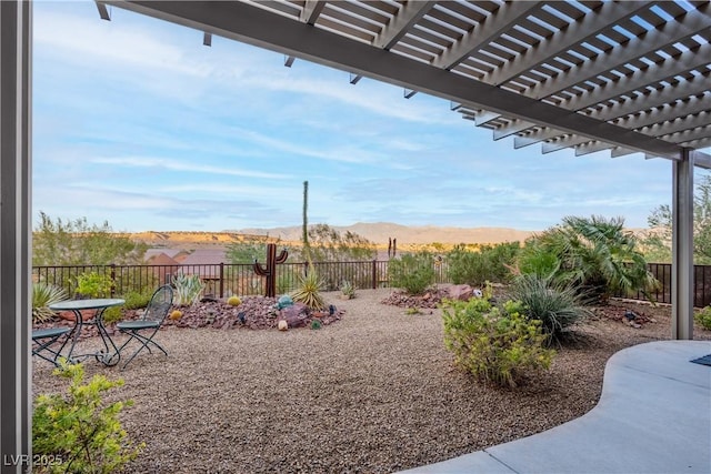 757 Bridle Path Ln, Mesquite, NV 89034 - fenced backyard with a pergola, a mountain view, and a patio