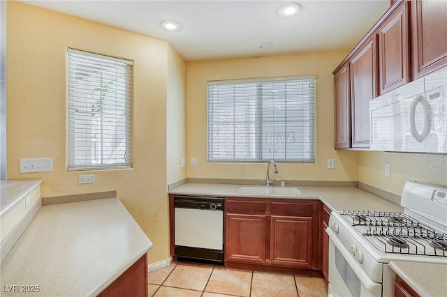 3905 Sweet Pine St Unit 102, Las Vegas, NV 89108 - kitchen with white appliances, light countertops, light tile patterned flooring, and recessed lighting