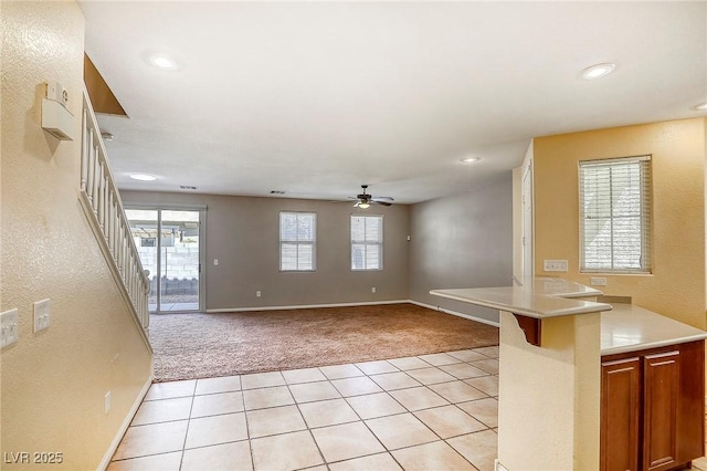 3905 Sweet Pine St Unit 102, Las Vegas, NV 89108 - unfurnished living room featuring light colored carpet, ceiling fan, plenty of natural light, light tile patterned floors, and recessed lighting