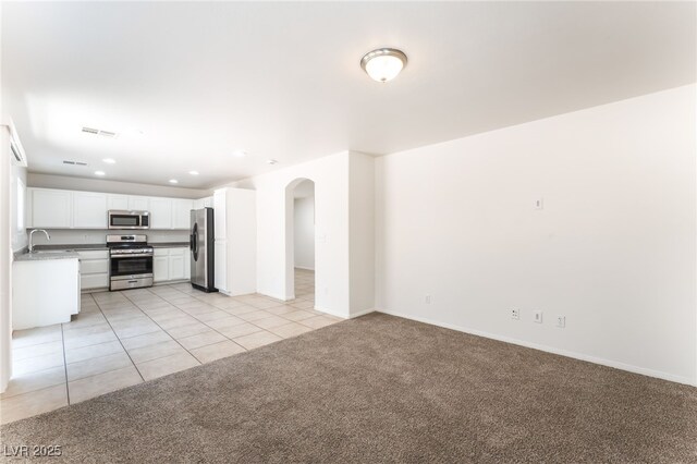 7553 Virginia Dale St, Las Vegas, NV 89131 - unfurnished living room with light colored carpet, recessed lighting, light tile patterned flooring, and arched walkways