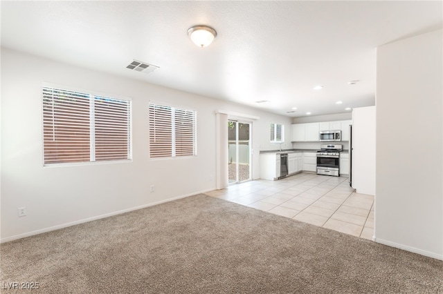 7553 Virginia Dale St, Las Vegas, NV 89131 - unfurnished living room featuring light carpet, light tile patterned flooring, and recessed lighting