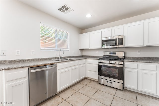 7553 Virginia Dale St, Las Vegas, NV 89131 - kitchen featuring stainless steel appliances, light tile patterned floors, white cabinetry, and recessed lighting