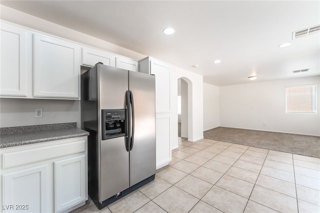 7553 Virginia Dale St, Las Vegas, NV 89131 - kitchen featuring stainless steel fridge, light colored carpet, white cabinetry, recessed lighting, and arched walkways