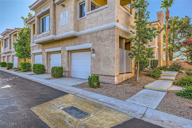 251 S Green Valley Pkwy Unit 3222, Henderson, NV 89012 - view of side of home featuring a garage, stucco siding, and a tile roof
