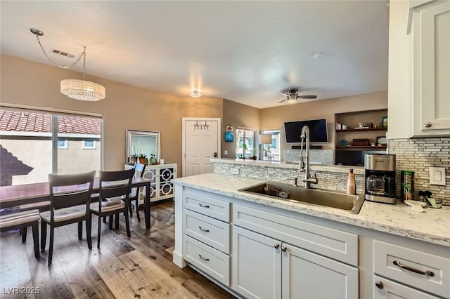 251 S Green Valley Pkwy Unit 3222, Henderson, NV 89012 - kitchen with backsplash, wood finished floors, and light stone countertops