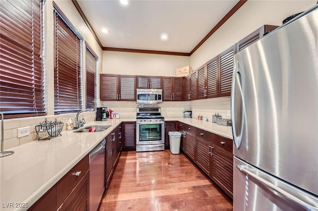 251 S Green Valley Pkwy Unit 3222, Henderson, NV 89012 - kitchen with stainless steel appliances, ornamental molding, decorative backsplash, light countertops, and light wood-type flooring