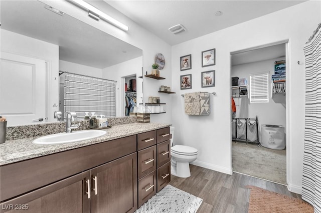 12280 Golden Wreath Rd Unit 3, Las Vegas, NV 89183 - bathroom with wood finished floors, vanity, and a spacious closet
