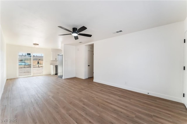 1648 J St, Las Vegas, NV 89106 - unfurnished living room featuring a ceiling fan and wood finished floors