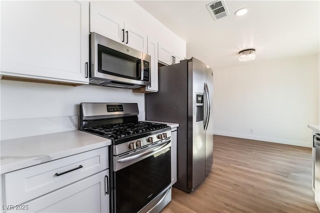 1648 J St, Las Vegas, NV 89106 - kitchen featuring stainless steel appliances, light wood-style flooring, white cabinets, and recessed lighting