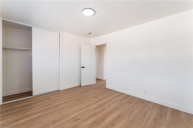 1648 J St, Las Vegas, NV 89106 - unfurnished bedroom with light wood-style flooring and a closet