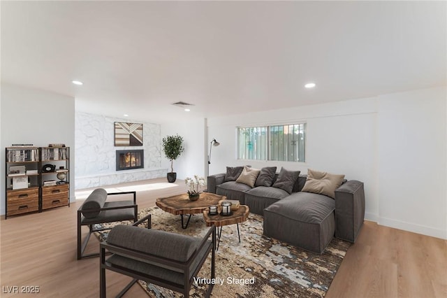 3320 Osage Ave, Las Vegas, NV 89101 - living area featuring a stone fireplace, light wood-type flooring, and recessed lighting