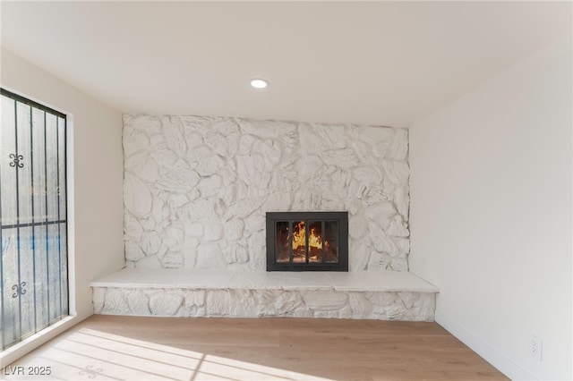 3320 Osage Ave, Las Vegas, NV 89101 - detailed view of wood finished floors, a stone fireplace, and recessed lighting