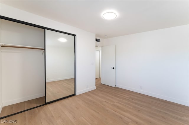 3320 Osage Ave, Las Vegas, NV 89101 - unfurnished bedroom with light wood-style flooring and a closet