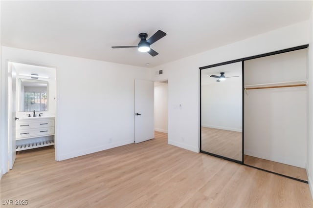 3320 Osage Ave, Las Vegas, NV 89101 - unfurnished bedroom with light wood-style flooring, a closet, ensuite bath, and a ceiling fan