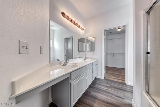 2766 Red Vista Ct, Henderson, NV 89074 - bathroom with double vanity, a shower, wood finished floors, and a spacious closet