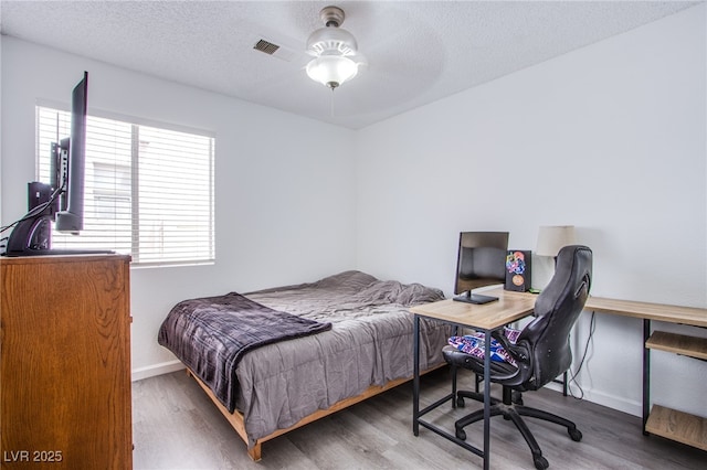 2752 Devita Cir, Las Vegas, NV 89117 - bedroom featuring wood finished floors, an office area, a textured ceiling, and ceiling fan