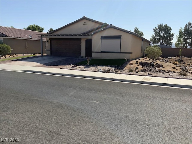 5363 S Juneau St, Pahrump, NV 89061 - ranch-style house featuring an attached garage and concrete driveway