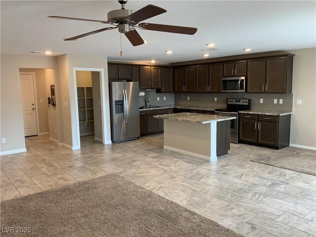 5363 S Juneau St, Pahrump, NV 89061 - kitchen featuring stainless steel appliances, dark brown cabinets, decorative backsplash, a ceiling fan, and recessed lighting