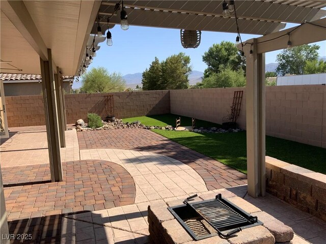 5363 S Juneau St, Pahrump, NV 89061 - fenced backyard with a patio area and a mountain view
