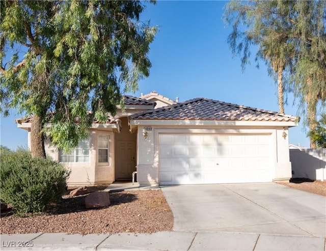 4848 Cutting Diamond Ct, North Las Vegas, NV 89081 - mediterranean / spanish home featuring stucco siding, concrete driveway, an attached garage, and a tiled roof