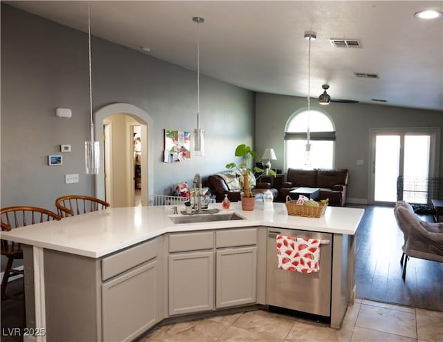 4848 Cutting Diamond Ct, North Las Vegas, NV 89081 - kitchen featuring stainless steel dishwasher, open floor plan, vaulted ceiling, light countertops, and arched walkways