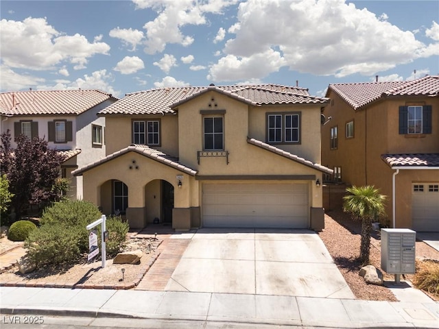 5620 Siena Rose St, North Las Vegas, NV 89031 - mediterranean / spanish home with stucco siding, concrete driveway, an attached garage, and a tiled roof
