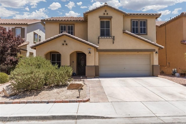 5620 Siena Rose St, North Las Vegas, NV 89031 - mediterranean / spanish-style home featuring stucco siding, a garage, a tiled roof, and concrete driveway