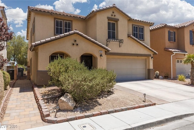 5620 Siena Rose St, North Las Vegas, NV 89031 - mediterranean / spanish home with a garage, stucco siding, a tiled roof, and concrete driveway