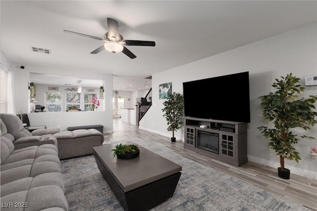 5620 Siena Rose St, North Las Vegas, NV 89031 - living room featuring plenty of natural light, stairs, ceiling fan, and wood finished floors