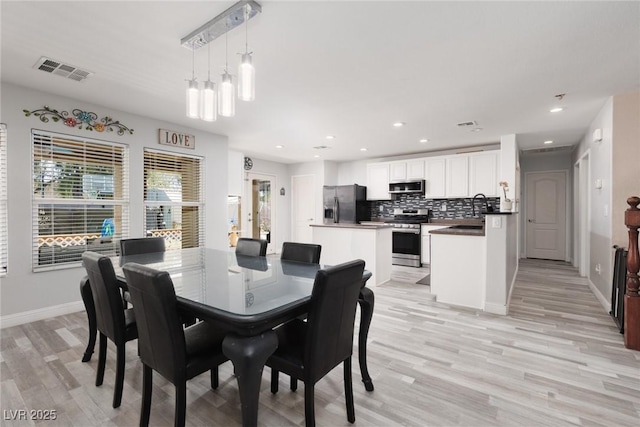 5620 Siena Rose St, North Las Vegas, NV 89031 - dining space with light wood finished floors and recessed lighting