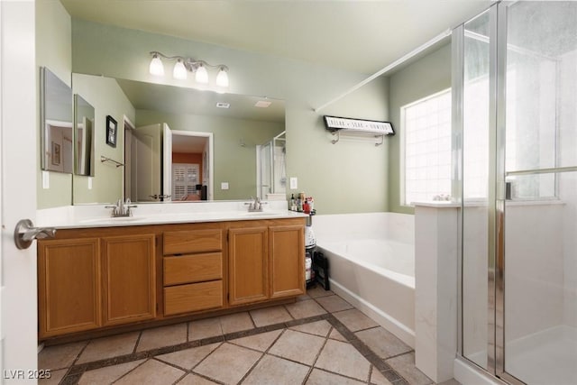 5620 Siena Rose St, North Las Vegas, NV 89031 - full bath with double vanity, tile patterned flooring, a garden tub, a shower stall, and inlaid floor details