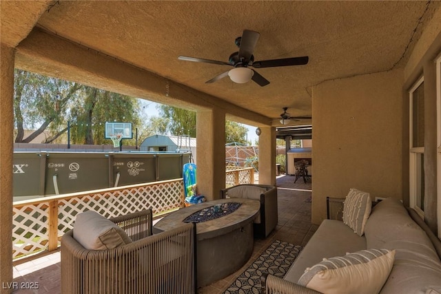 5620 Siena Rose St, North Las Vegas, NV 89031 - view of patio / terrace featuring ceiling fan and an outdoor living space with a fire pit