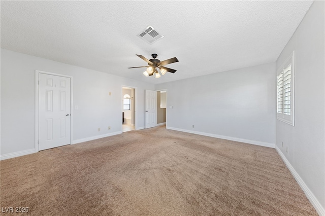 9409 Kayla Ct, Las Vegas, NV 89134 - empty room featuring a ceiling fan, light carpet, healthy amount of natural light, and a textured ceiling