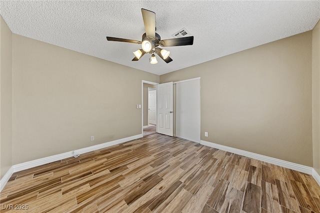 9409 Kayla Ct, Las Vegas, NV 89134 - unfurnished bedroom with wood finished floors, a closet, a ceiling fan, and a textured ceiling