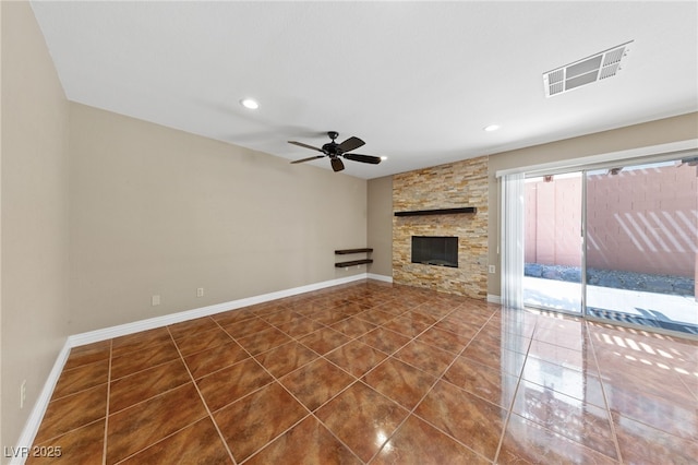 9409 Kayla Ct, Las Vegas, NV 89134 - unfurnished living room featuring tile patterned flooring, a ceiling fan, recessed lighting, and a stone fireplace