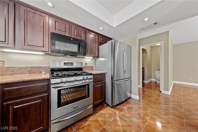 9409 Kayla Ct, Las Vegas, NV 89134 - kitchen featuring stainless steel appliances, light stone counters, recessed lighting, and light tile patterned flooring