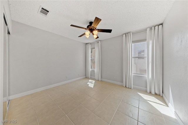 9409 Kayla Ct, Las Vegas, NV 89134 - unfurnished room with a textured ceiling, a ceiling fan, and light tile patterned floors
