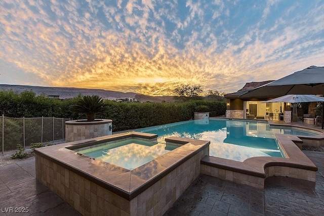 15 Golden Sunray Ln, Las Vegas, NV 89135 - pool at dusk with a patio and a pool with connected hot tub