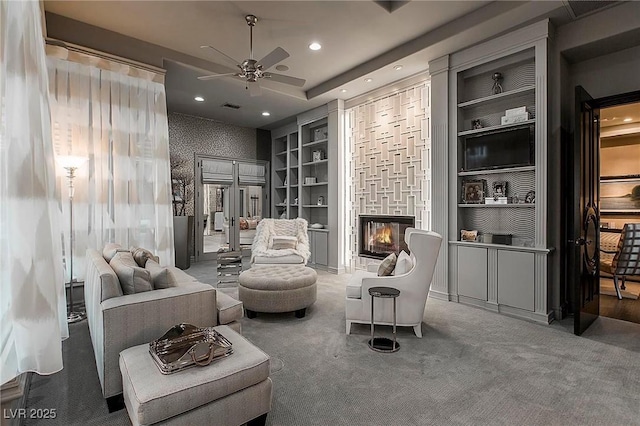 15 Golden Sunray Ln, Las Vegas, NV 89135 - living area with ceiling fan, carpet, a glass covered fireplace, recessed lighting, and built in shelves