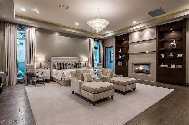 15 Golden Sunray Ln, Las Vegas, NV 89135 - bedroom featuring a raised ceiling, multiple windows, wood finished floors, and recessed lighting
