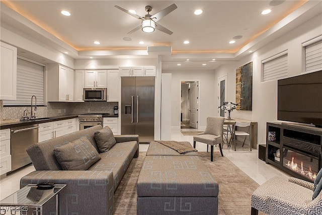 15 Golden Sunray Ln, Las Vegas, NV 89135 - living room featuring a tray ceiling, ceiling fan, light marble finish flooring, and recessed lighting