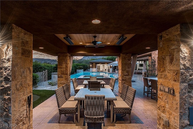 15 Golden Sunray Ln, Las Vegas, NV 89135 - view of patio / terrace with outdoor dining area, a ceiling fan, and a pool with connected hot tub