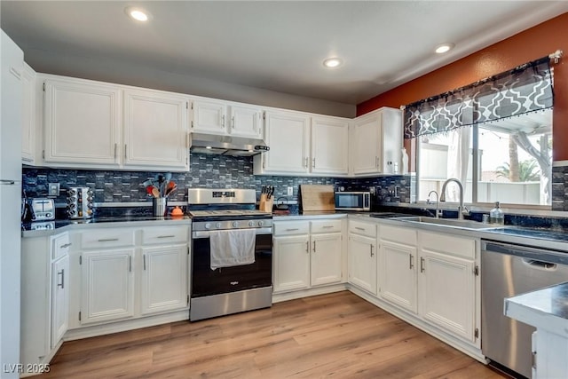 1048 Menands Ave, Las Vegas, NV 89123 - kitchen featuring stainless steel appliances, under cabinet range hood, white cabinetry, and recessed lighting
