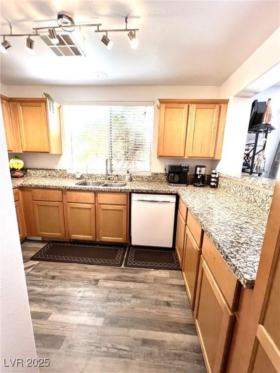 39 Belle La Blanc Ave, Las Vegas, NV 89123 - kitchen with dishwasher, wood finished floors, rail lighting, light stone counters, and light brown cabinetry