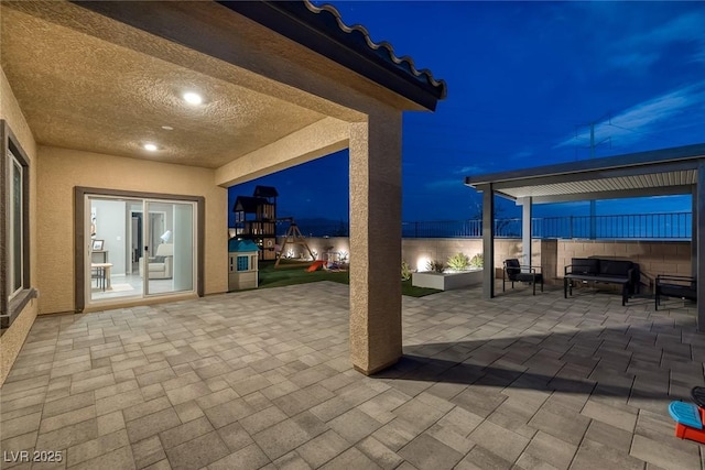 5234 Savannah Rose St, Las Vegas, NV 89149 - patio at night with a patio area and an outdoor hangout area