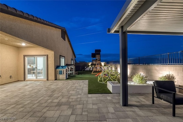 5234 Savannah Rose St, Las Vegas, NV 89149 - patio at twilight featuring a playground, a patio, and a yard