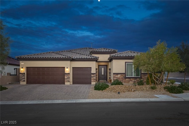5234 Savannah Rose St, Las Vegas, NV 89149 - view of front of house with stone siding, stucco siding, a garage, decorative driveway, and a tile roof